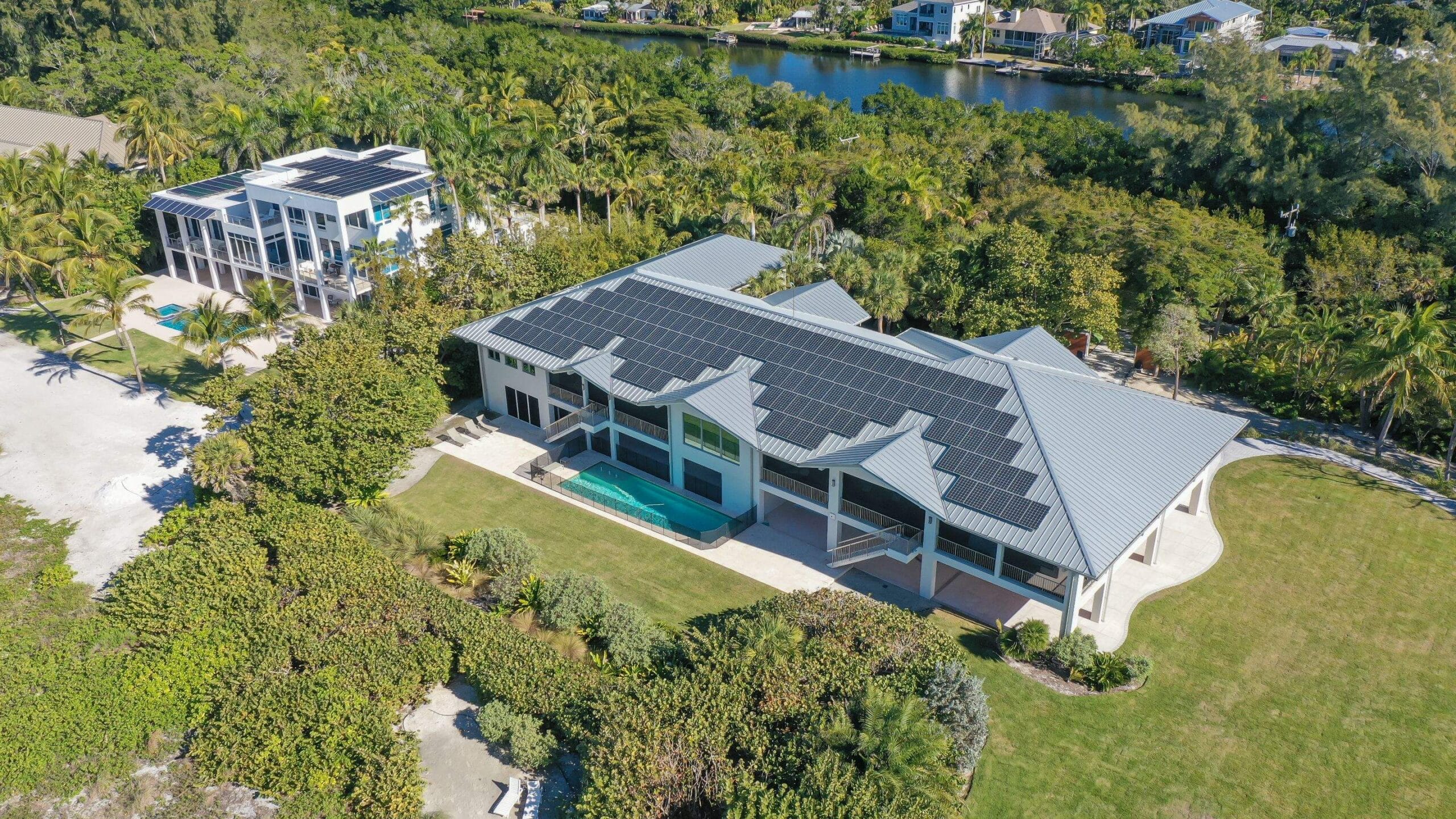 Large house with solar panels, pool, and gardens